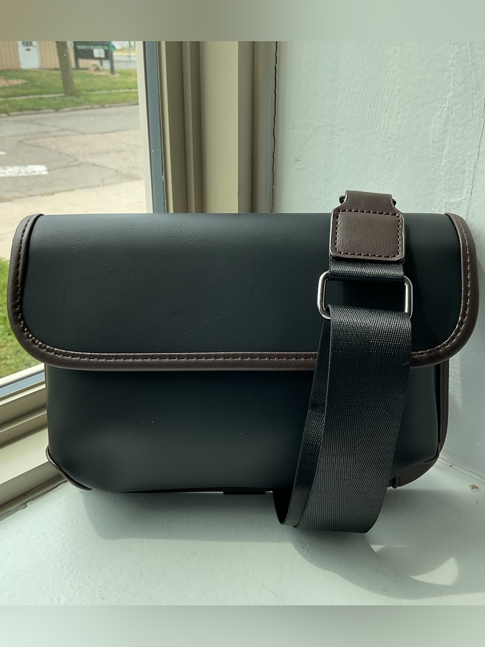 Black Crossbody Bag with Brown Trim and Adjustable Strap
